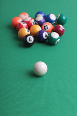 Billiard balls on a green table close-up