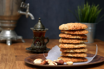 Oatmeal Cookies with nuts and tea at Samovar on a wooden table