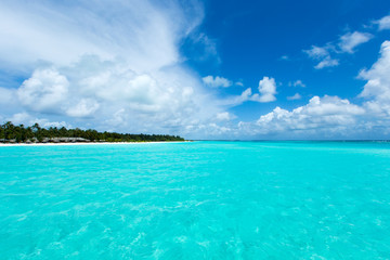 Fototapeta na wymiar tropical Maldives island with white sandy beach and sea