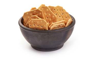 Bowl of salted cracker biscuits, close-up, isolated on white background