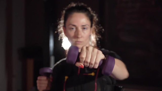 EMS electro stimulation sports equipment in gym. Woman doing exercises