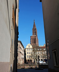 Cathedral viewed between the walls of a narrow street in Strasbourg - France