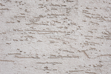 The texture of the wall with scratches and cracks on all sides.