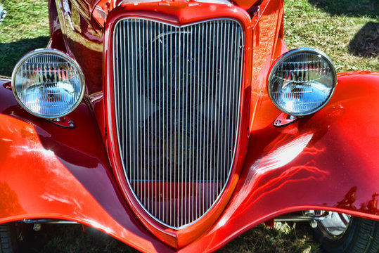 The vibrant grill and headlights of an old car.