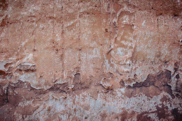 old wall with crumbling plaster texture background.