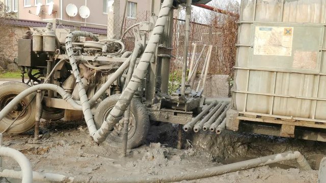 Dirty installation drills a hole in the ground beneath the well