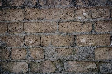 old brick wall and missing bricks in ruins.