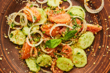 Fresh spring detox mix salad with vegetables such as tomatoes, cucumbers and onion
