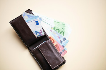 Euro banknotes in leather wallet.