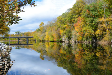 Water reflections along a lazy river in fall.