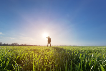 Fototapeta premium man in field at sunset / bright spring photo Ukraine
