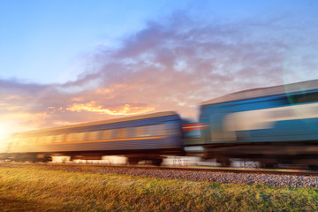 abstract photo of a train at the sunset / passenger train in motion