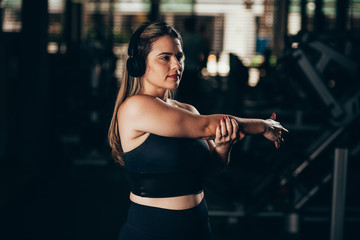 Young woman stretching at the gym. Workout concept