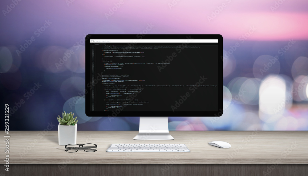 Fototapete Concept of programming on a computer. Work desk with computer display and text editor.