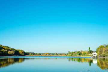 Amazing landscape of lake with clear green water and Perfect blue sky. Ukraine