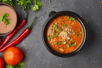 Traditional Georgian soup Kharcho with meat and rice on dark stone background