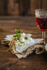 serving on a wooden table (flowers, napkin, wine glass, other objects). Top view. Copy space