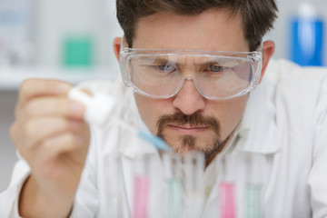 researcher working with a pipette in a biochemistry lab