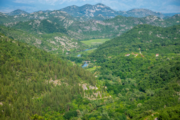 Fototapeta na wymiar The picturesque meandering river flows among green mountains.