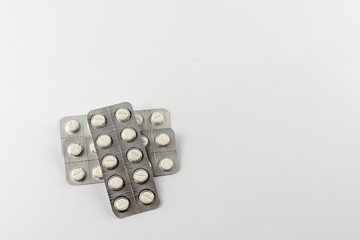 Strips with white pills in blister pack isolated on a white back ground