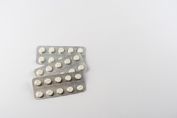 Strips with white pills in blister pack isolated on a white back ground