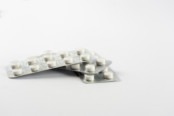 Strips with white pills in blister pack isolated on a white back ground