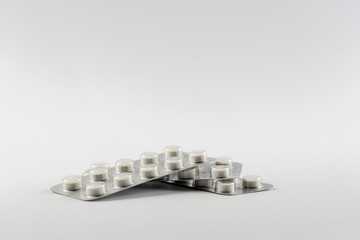 Strips with white pills in blister pack isolated on a white back ground