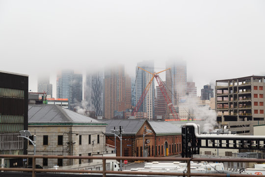 Construction cranes in the fog