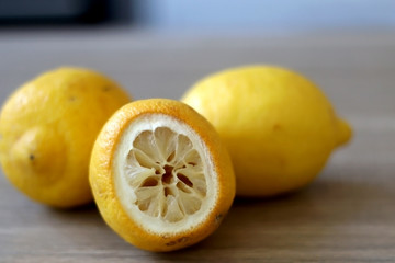 Raw organic lemons on a wooden table. Selective focus.