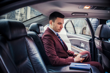 Confident businessman in his luxury sedan car