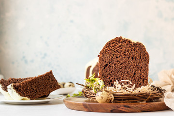 Traditional Orthodox Easter sweet bread or cake with chocolate. Chocolate Kulich  decorated with orange glaze.