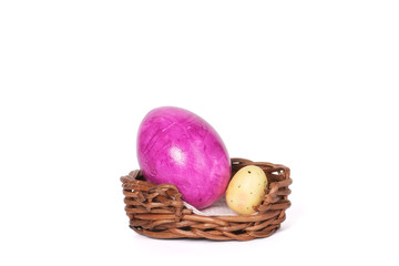 Bird and colorful eggs in Easter basket