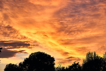 Fototapeta na wymiar Gorgeous panorama scenic of the strong sunset with cloud on the orange and red sky
