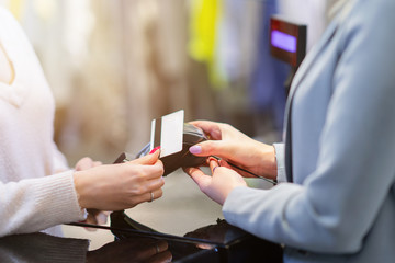 Happy woman shopping for clothes in store