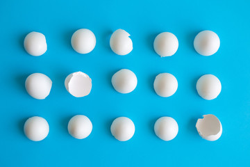 Close up of white eggshells abstract isolated on blue.
