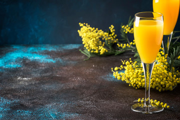 Classic alcohol cocktail mimosa with orange juice and cold dry champagne or sparkling wine in...