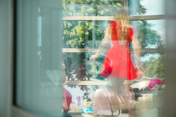 Reflection on glass window of girls party. Young women celebrating birthday or bachelorette party....