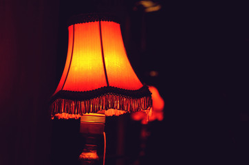 Decorative table lamp in bedroom. Cosy atmosphere at home