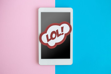 Top view of tablet or smartphone with lol in pop art style abstract.