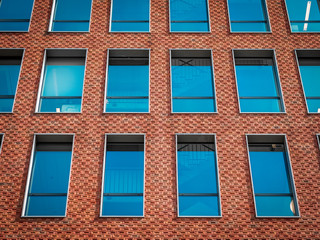 Rectangle windows on a brick wall of the modern business-building (perspective view) 