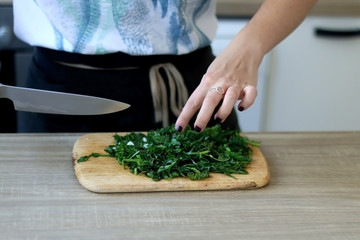 Unrecognizable person cutting chicory in the kitchen. Selective focus.