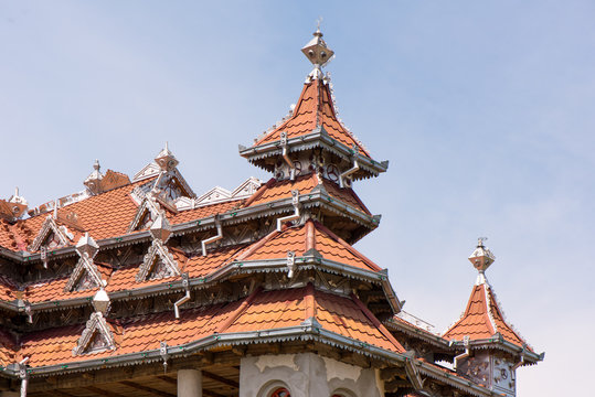 Traditional gypsy house with luxury decorations and ornaments on the roof in Huedin, Romania being under construction. 