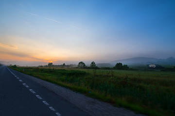 Beautiful morning on road. Sun is rising in mountains. Concept of road trip and traveling with car around Europe, Romania