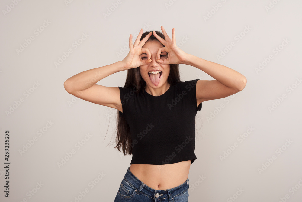 Wall mural Portrait of young beautiful cute cheerful girl smiling looking at camera over white background