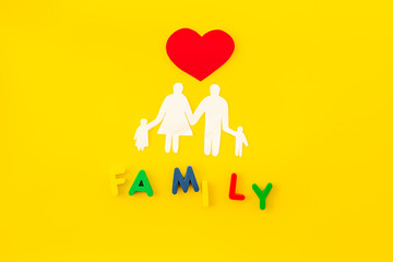 Family copy for adoption child concept on yellow background top view