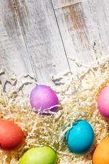 Fototapeta na wymiar Bright And Colorful Easter Eggs On Weathered Wood
