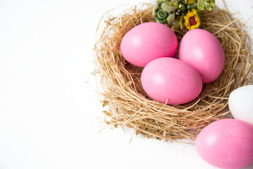 Fototapeta na wymiar Easter colored pink eggs in egg nest, soft focus image. Happy Easter Card