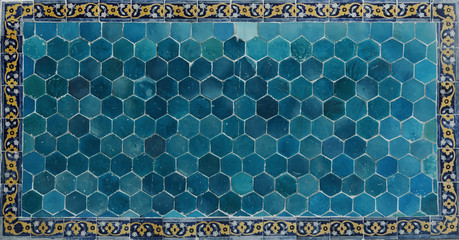 Ancient tile. Ceramic wall in Bukhara. Islamic ceramic decor.