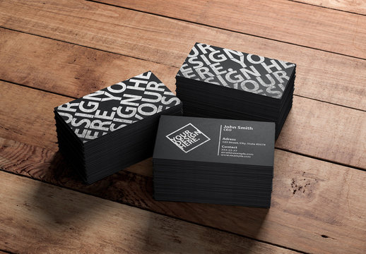3 Stacks of Black Business Cards on a Wooden Background Mockup
