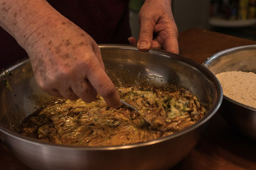 using a spoon to mix a bowl of ingredients